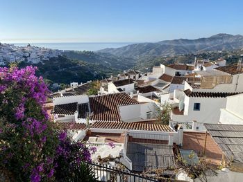 High angle view of townscape by mountain against sky