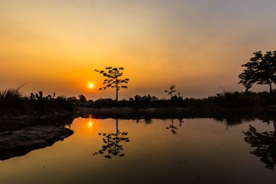 Scenic view of lake against orange sky
