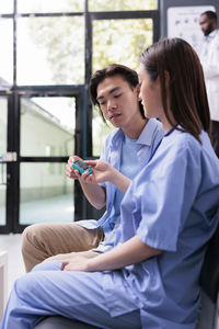 Portrait of doctor examining patient in hospital