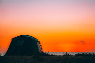 Scenic view of sea against orange sky