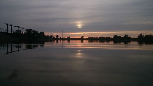 Scenic view of lake against sky during sunset