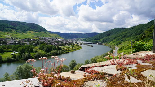 Scenic view of moselle river valley amidst trees against sky