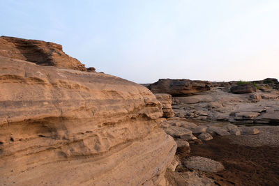 Rock formations on landscape against clear sky