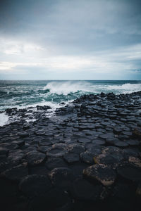 Scenic view of giants causeway against sky