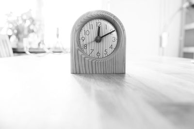 Close-up of clock on table at home
