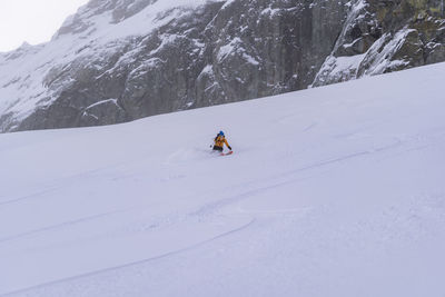 Person skiing on snowcapped mountain