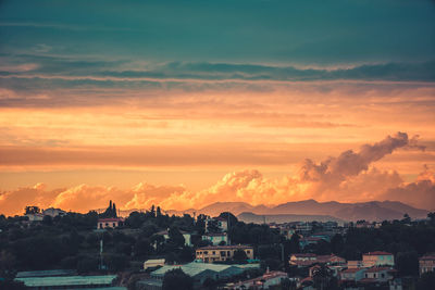 High angle shot of townscape against orange sky