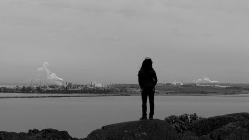 Rear view of sea against sky