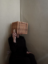 Woman with obscured face using mobile phone