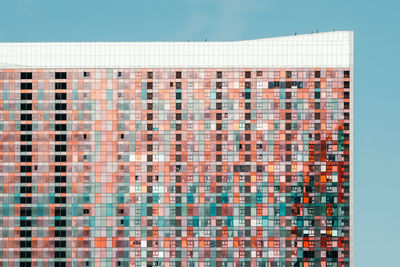 Full frame shot of apartment building against blue sky