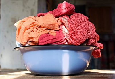 Close-up of red rose in bowl on table