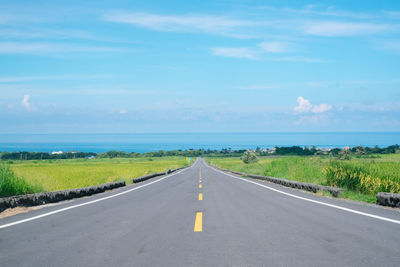 Road passing through landscape against sky