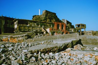 Abandoned building against clear blue sky