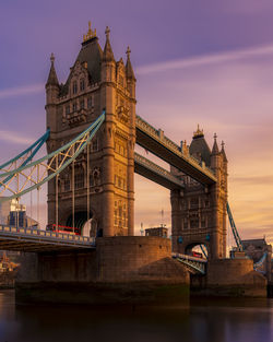 View of bridge over river at sunset