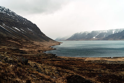 Scenic view of lake and mountains against sky