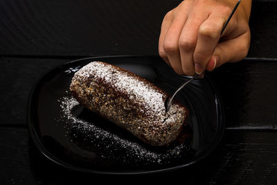 Cropped hand of person preparing food