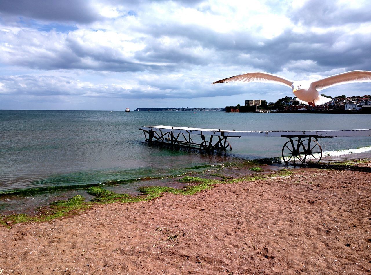 water, sea, beach, sky, horizon over water, cloud - sky, tranquil scene, shore, tranquility, scenics, sand, cloudy, beauty in nature, nature, cloud, idyllic, pier, calm, day, coastline