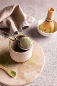 Matcha tea accessories on a white stone board