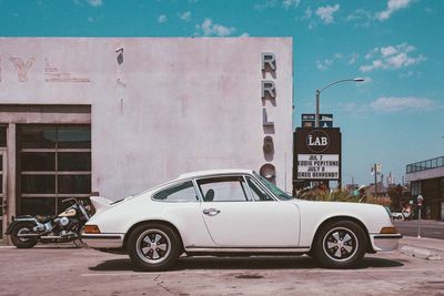 Vintage car against sky in city