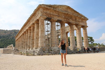 People standing in front of historical building