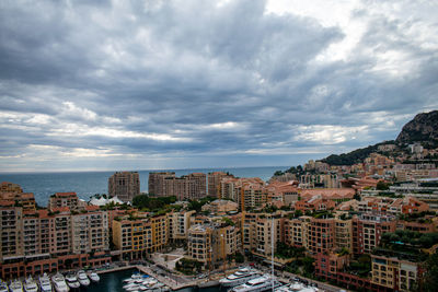 High angle view of buildings by sea against sky