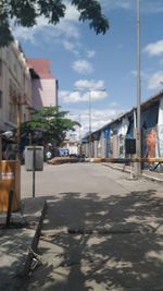 Street amidst buildings in city against sky