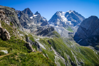 Scenic view of snowcapped mountains against clear sky