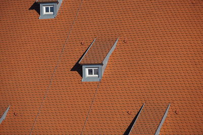 Low angle view of house roof against building