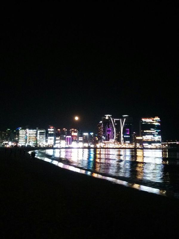busan at night. · South Korea city lights Night Lights Night Photography Darkness Water reflections sea beach