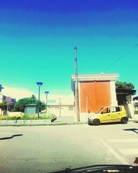 Cars on road against blue sky