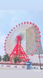 Low angle view of ferris wheel against sky