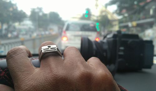 Close-up of hand holding car