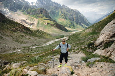 A woman with backpack in the mountains