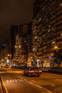 Illuminated city street and buildings at night