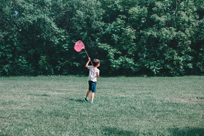 Full length of man playing on grassy field