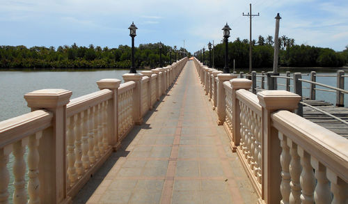 View of bridge over calm sea against sky