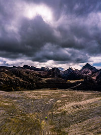 Scenic view of mountains against cloudy sky