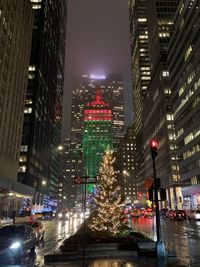 Illuminated city street and buildings at night