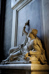 Low angle view of statue against building