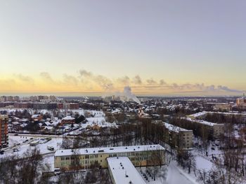 High angle view of cityscape against clear sky during sunset