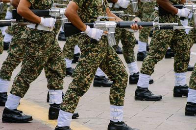 Low section of army soldiers with rifle during parade