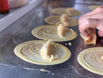 Midsection of person preparing food in kitchen