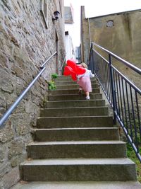 Low angle view of steps against red wall