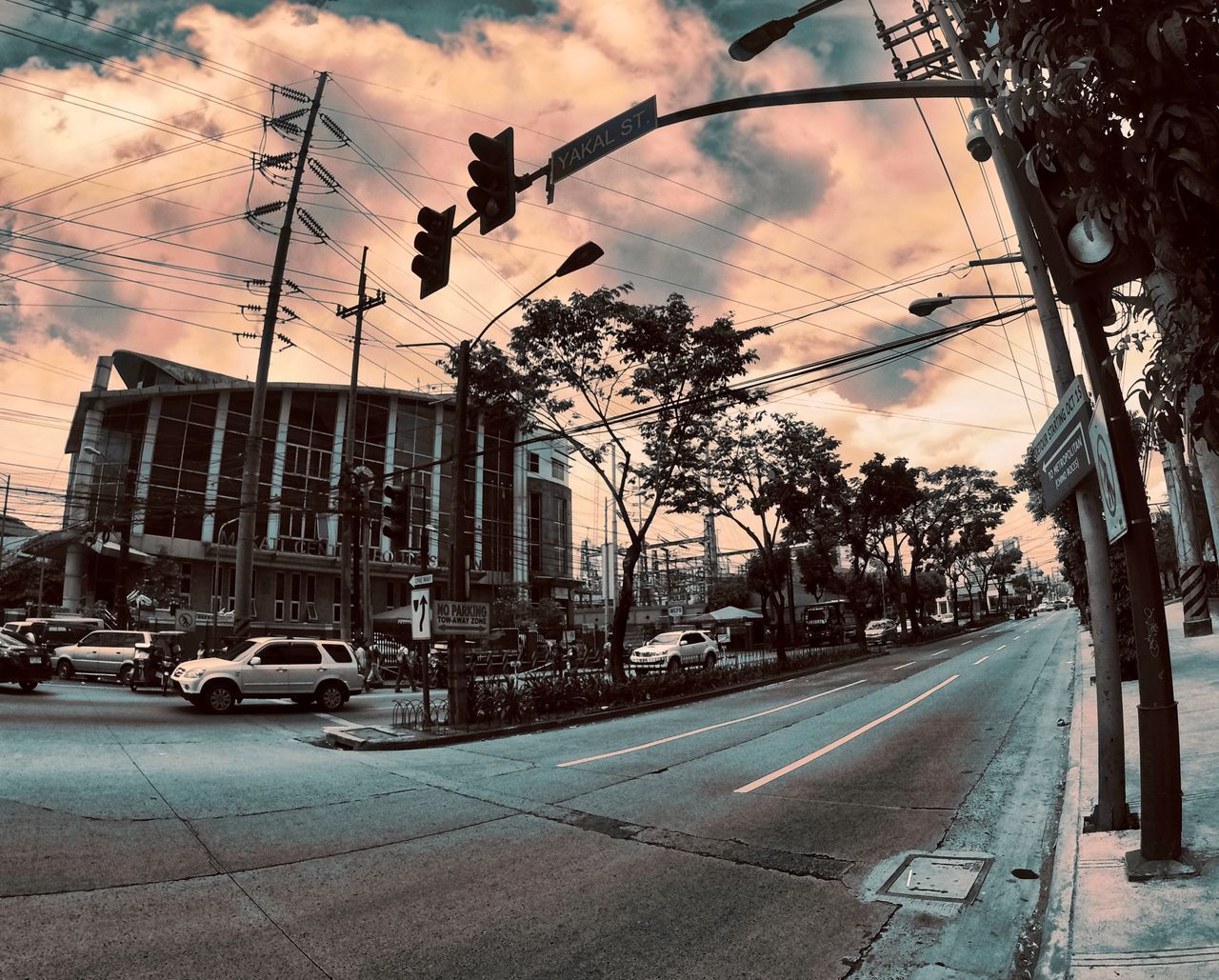 CARS ON ROAD AGAINST SKY AT SUNSET