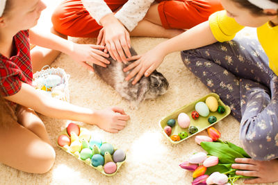 Girl playing with rabbit at home