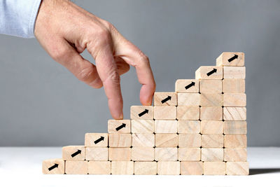 Midsection of person holding toy against white background