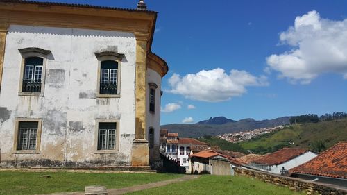 Houses in town against sky