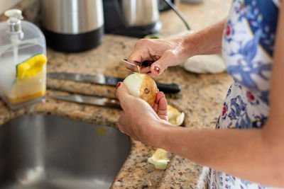 Cook peeling onion in the kitchen. healthy eating.