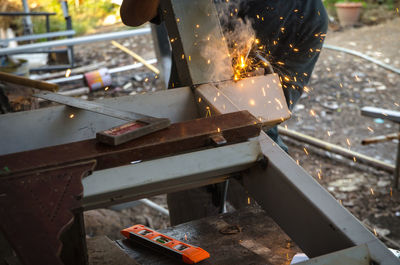 Low section of worker welding metal