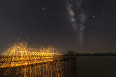 Scenic view of lake against sky at night